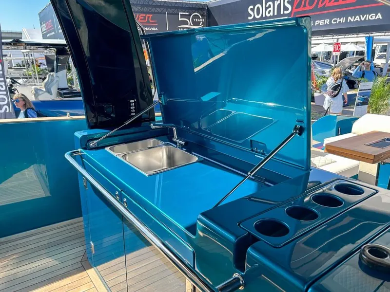 Slide: The Image of 2024 Solaris Power 52 Open yacht with sleek blue outdoor kitchen and sink. - 43