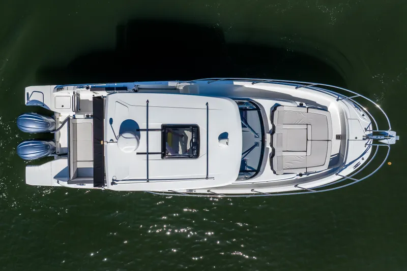 Slide: The Image of Overhead view of 2024 Jeanneau Leader 10.5 WA Series 2 boat on water. - 10