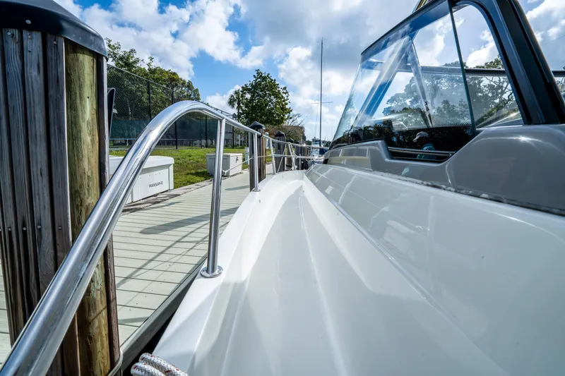 Slide: The Image of 2024 Jeanneau Leader 10.5 WA Series 2 docked, showcasing sleek design and polished railing. - 13
