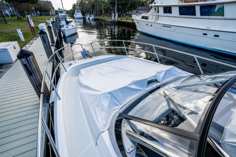 Slide: The Image of 2024 Jeanneau Leader 10.5 WA Series 2 docked at marina, covered deck visible. - 14