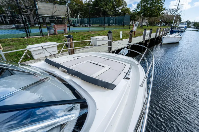 Slide: The Image of 2024 Jeanneau Leader 10.5 WA Series 2 docked by a tennis court. - 18