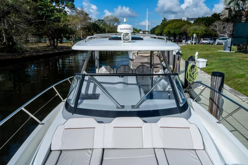Slide: The Image of 2024 Jeanneau Leader 10.5 WA Series 2 boat docked by a scenic canal. - 22