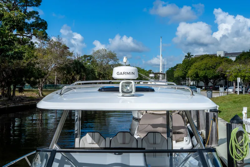 Slide: The Image of 2024 Jeanneau Leader 10.5 WA Series 2 boat docked, featuring Garmin equipment. - 23