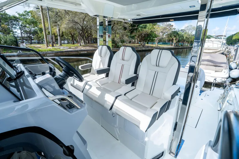 Slide: The Image of 2024 Jeanneau Leader 10.5 WA Series 2 cockpit with modern seating and steering wheel. - 29