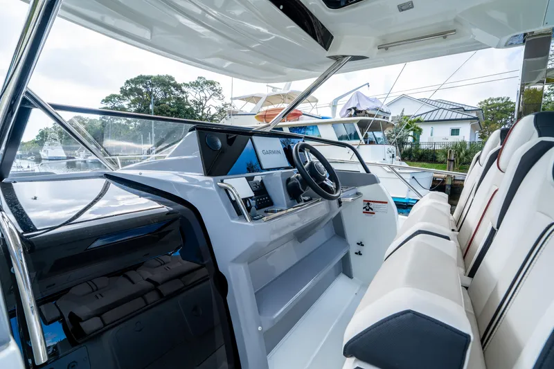 Slide: The Image of 2024 Jeanneau Leader 10.5 WA Series 2 cockpit with modern steering and seating. - 30