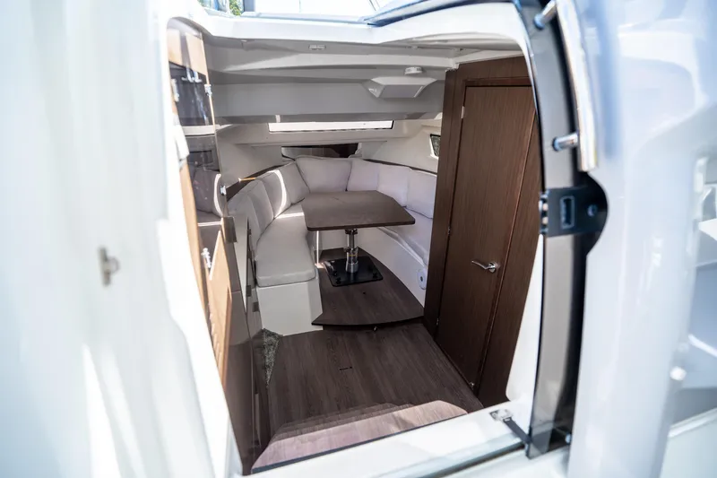 Slide: The Image of 2024 Jeanneau Leader 10.5 WA Series 2 cabin interior with seating and table. - 32