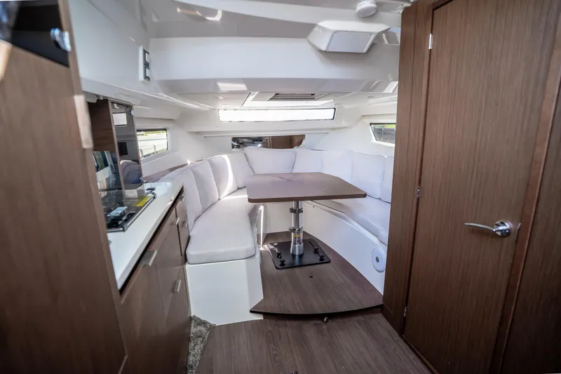 Slide: The Image of 2024 Jeanneau Leader 10.5 WA Series 2 interior with modern seating and dining area. - 33