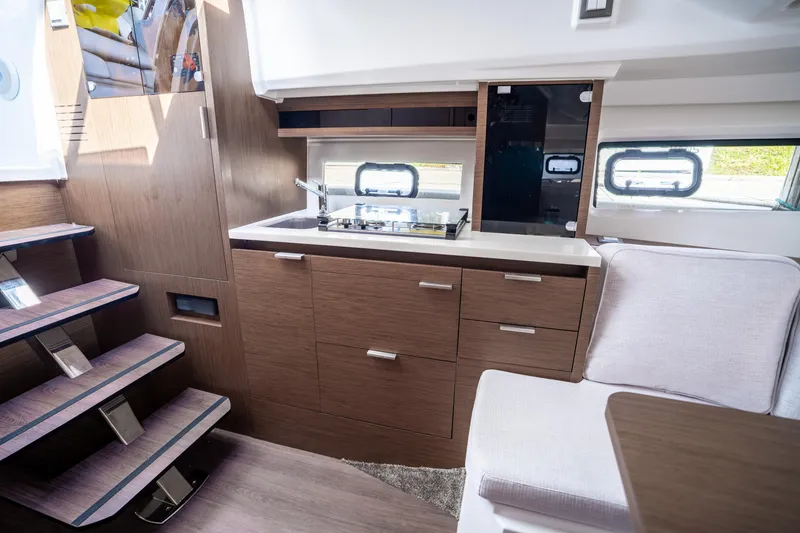 Slide: The Image of 2024 Jeanneau Leader 10.5 WA Series 2 interior with modern kitchen and seating area. - 34