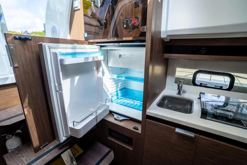 Slide: The Image of 2024 Jeanneau Leader 10.5 WA Series 2 interior kitchen with open fridge and sink. - 37