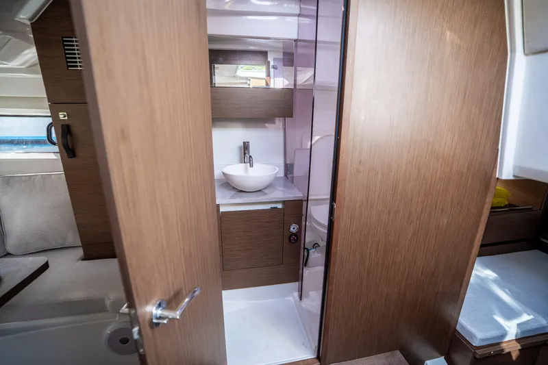 Slide: The Image of 2024 Jeanneau Leader 10.5 WA Series 2 interior bathroom with modern sink and wood finish. - 40