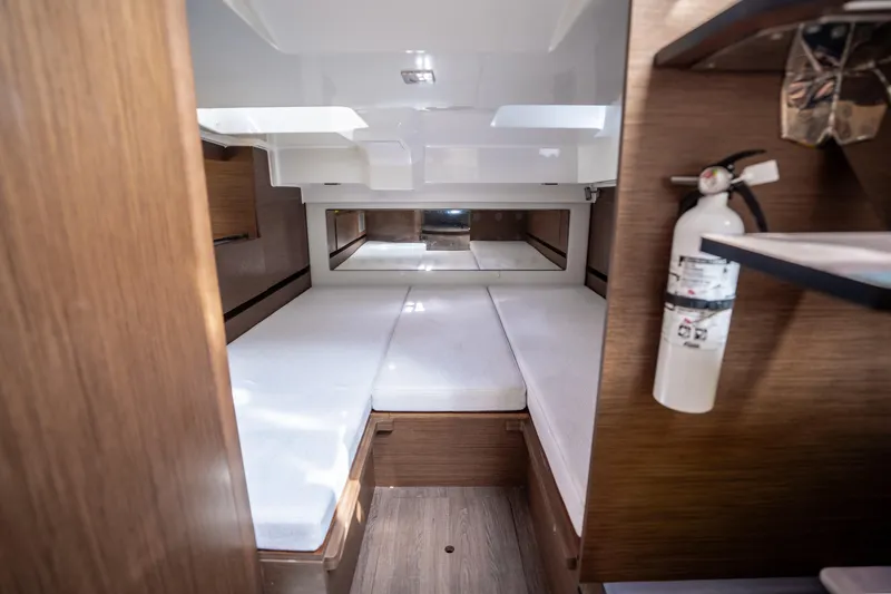 Slide: The Image of 2024 Jeanneau Leader 10.5 WA Series 2 cabin interior with white cushions and wood finish. - 42
