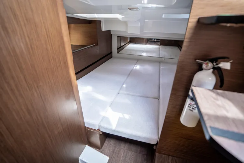Slide: The Image of 2024 Jeanneau Leader 10.5 WA Series 2 cabin interior with bed and fire extinguisher. - 45