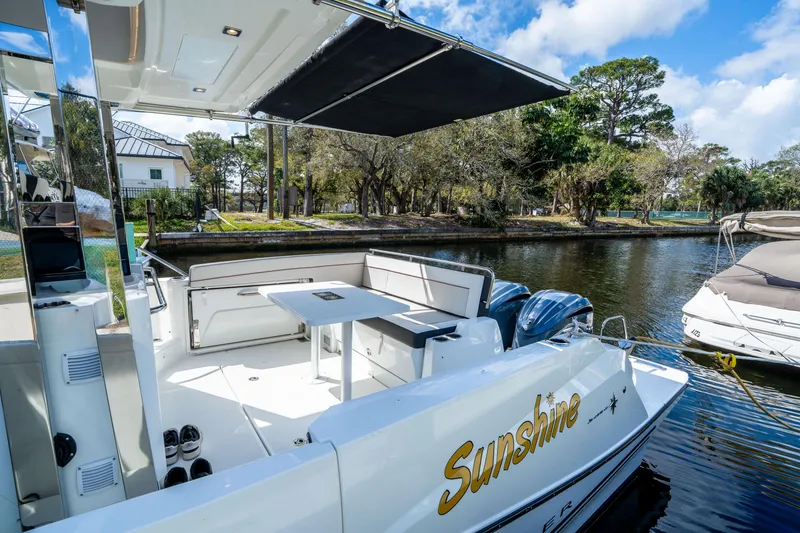 Slide: The Image of 2024 Jeanneau Leader 10.5 WA Series 2 boat docked, featuring spacious seating and canopy. - 50