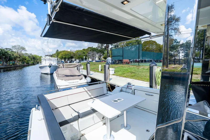 Slide: The Image of 2024 Jeanneau Leader 10.5 WA Series 2 docked, featuring spacious seating and table. - 52