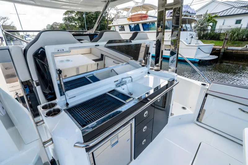 Slide: The Image of 2024 Jeanneau Leader 10.5 WA Series 2 boat with sleek outdoor kitchen setup. - 57