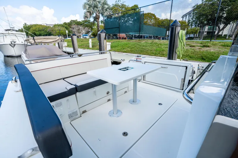 Slide: The Image of 2024 Jeanneau Leader 10.5 WA Series 2 boat deck with seating and table. - 63