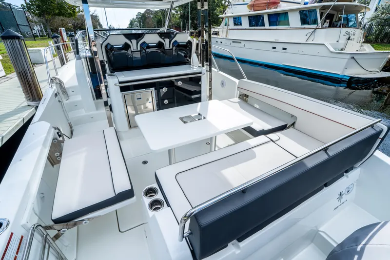 Slide: The Image of 2024 Jeanneau Leader 10.5 WA Series 2 boat interior with seating and table. - 66