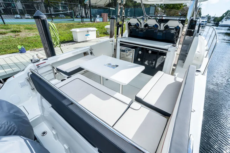 Slide: The Image of 2024 Jeanneau Leader 10.5 WA Series 2 boat interior with seating and table. - 68