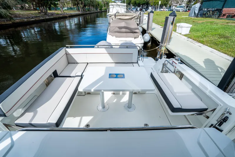 Slide: The Image of 2024 Jeanneau Leader 10.5 WA Series 2 boat interior with seating and table. - 69