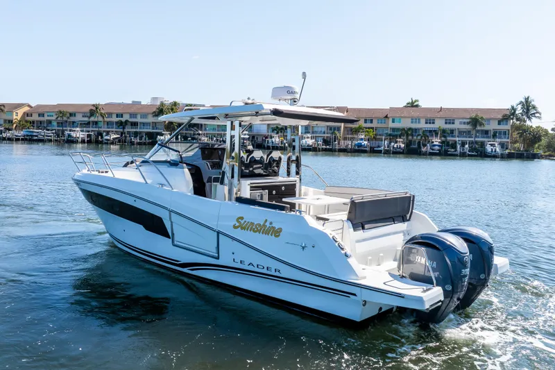 Slide: The Image of 2024 Jeanneau Leader 10.5 WA Series 2 boat cruising on a sunny waterfront. - 7