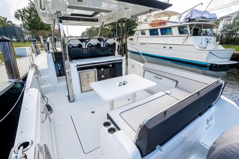 Slide: The Image of 2024 Jeanneau Leader 10.5 WA Series 2 boat interior with seating and table. - 70