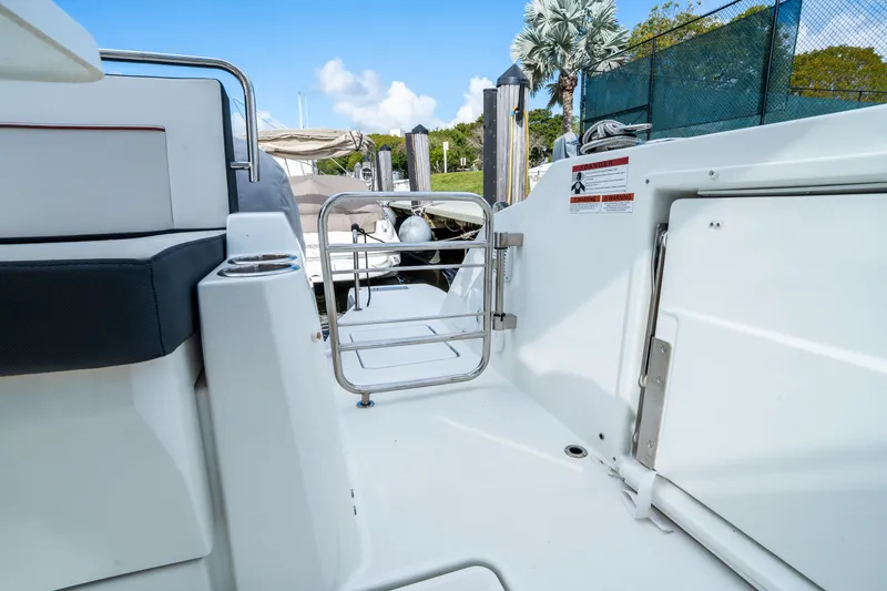 Slide: The Image of 2024 Jeanneau Leader 10.5 WA Series 2 boat deck with safety gate and seating. - 74