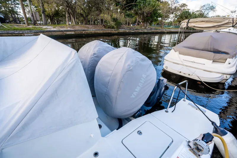 Slide: The Image of 2024 Jeanneau Leader 10.5 WA Series 2 with Yamaha engines, docked in a serene marina. - 76