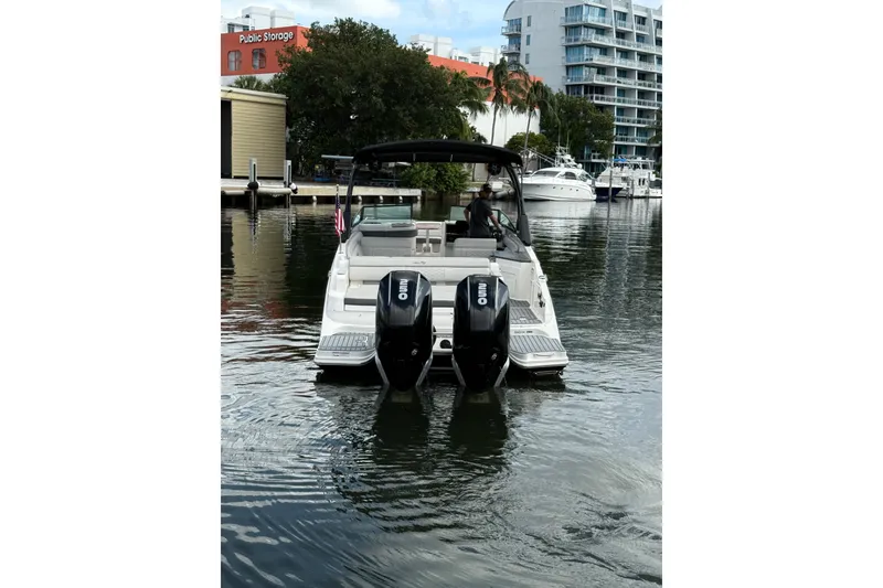 Slide: The Image of 2021 Sea Ray SDX 290 Outboard boat on water near urban marina. - 17
