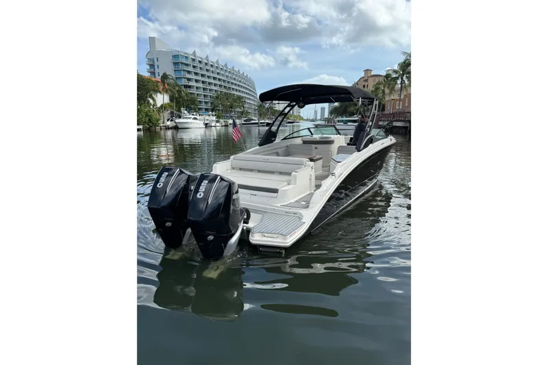 Slide: The Image of 2021 Sea Ray SDX 290 Outboard boat on a calm waterway, featuring dual engines. - 19