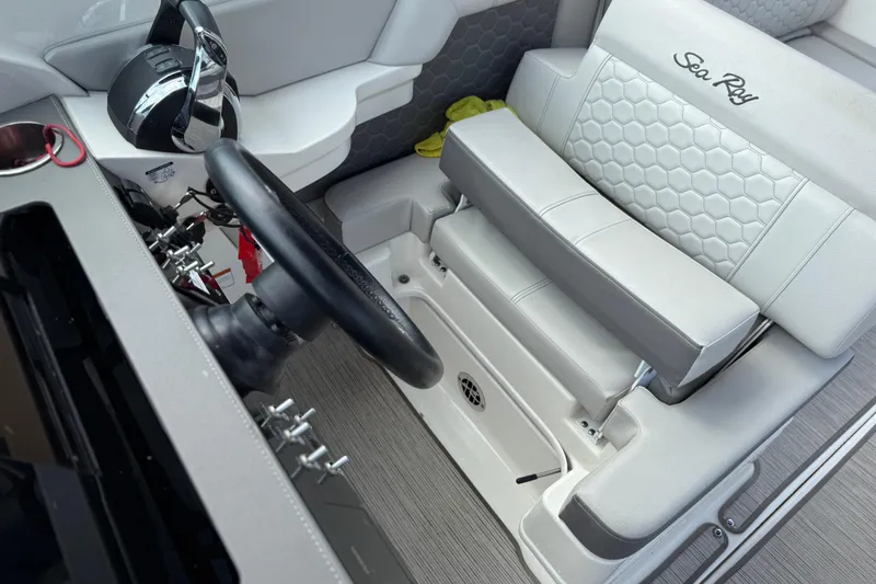 Slide: The Image of 2021 Sea Ray SDX 290 Outboard helm with steering wheel and luxurious seating. - 32