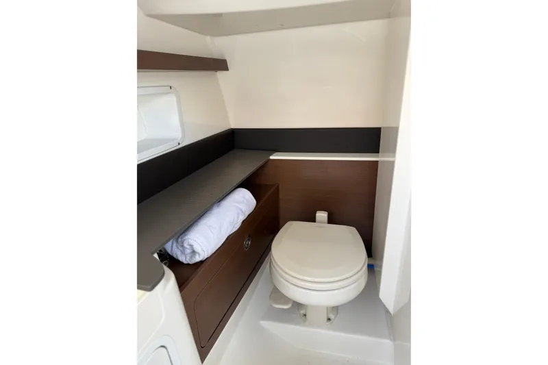Slide: The Image of 2021 Sea Ray SDX 290 Outboard boat interior bathroom with toilet and storage. - 37