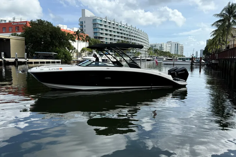 Slide: The Image of 2021 Sea Ray SDX 290 Outboard boat docked in a scenic urban marina. - 5