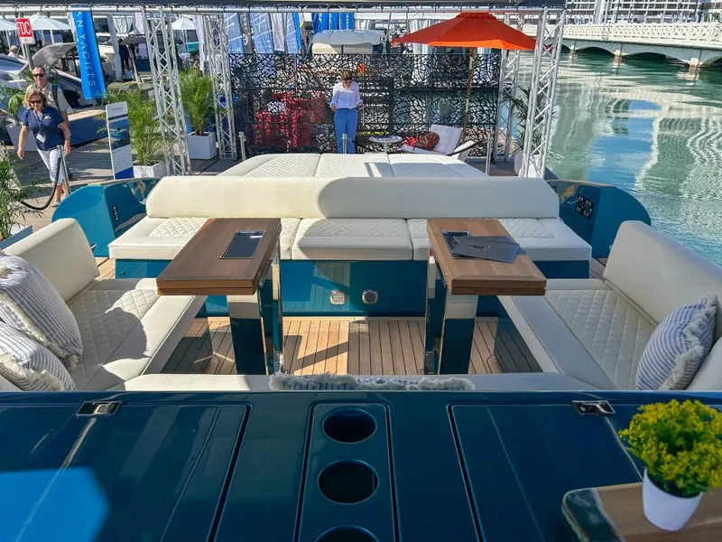 Slide: The Image of 2024 Solaris Power 52 Open luxury yacht interior with seating and tables at a marina. - 36