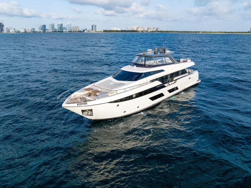 Slide: The Image of 2020 Ferretti Yachts 920 cruising on open water with city skyline in background. - 4