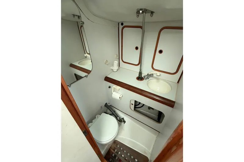 Slide: The Image of Bathroom interior of 1990 Beneteau Oceanis 430 yacht, featuring sink and toilet. - 10