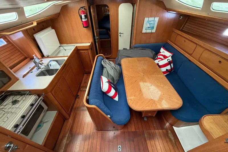 Slide: The Image of Interior of 1990 Beneteau Oceanis 430 sailboat with kitchen and cozy seating area. - 12