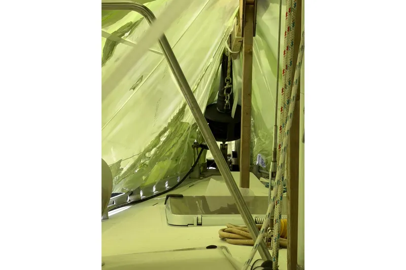Slide: The Image of Interior view of a 1990 Beneteau Oceanis 430 sailboat under protective cover. - 13