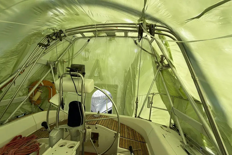 Slide: The Image of Interior view of a 1990 Beneteau Oceanis 430 sailboat under protective cover. - 14