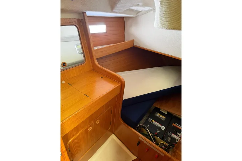 Slide: The Image of Interior cabin of 1990 Beneteau Oceanis 430 sailboat with wooden cabinetry and storage. - 3