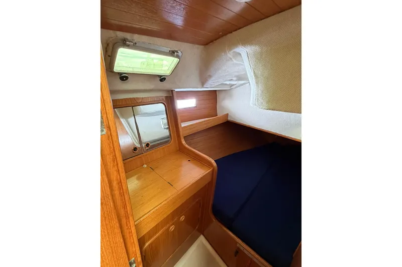 Slide: The Image of Cozy cabin interior of 1990 Beneteau Oceanis 430 sailboat with wooden furnishings. - 4