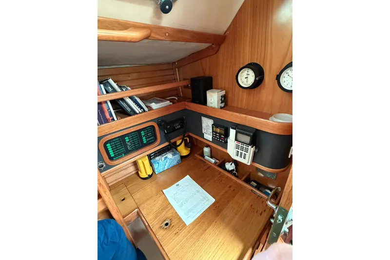 Slide: The Image of Navigation station of 1990 Beneteau Oceanis 430 yacht with instruments and books. - 6