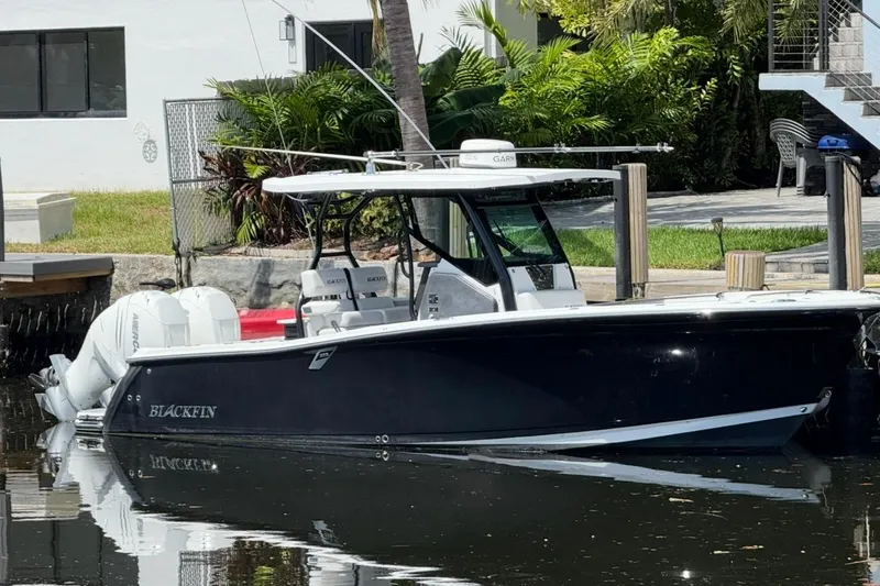 The Image of 2019 Blackfin 272 CC boat docked by a waterfront home. - 0