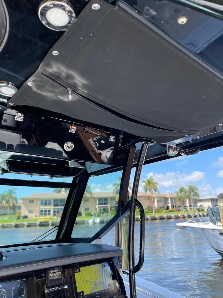 Slide: The Image of 2019 Blackfin 272 CC boat interior with modern dashboard and waterfront view. - 26