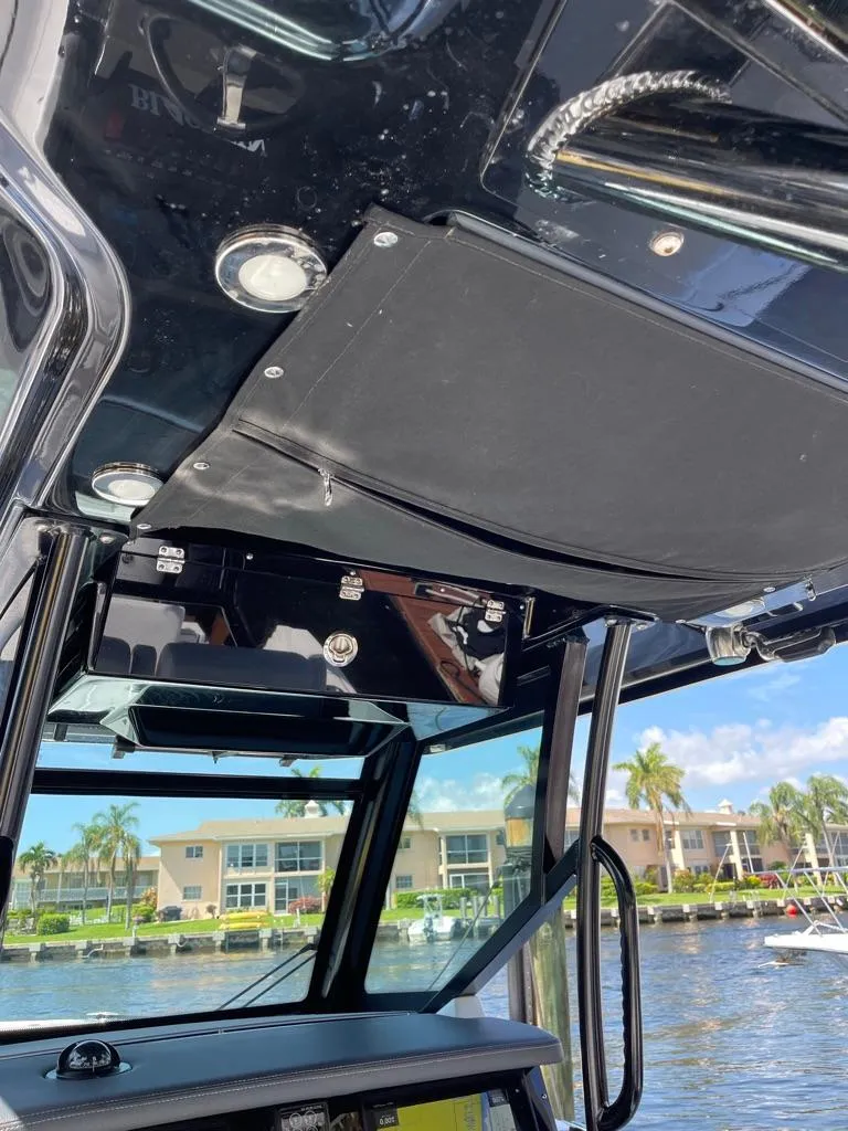 Slide: The Image of 2019 Blackfin 272 CC boat interior with sleek design and waterfront view. - 27