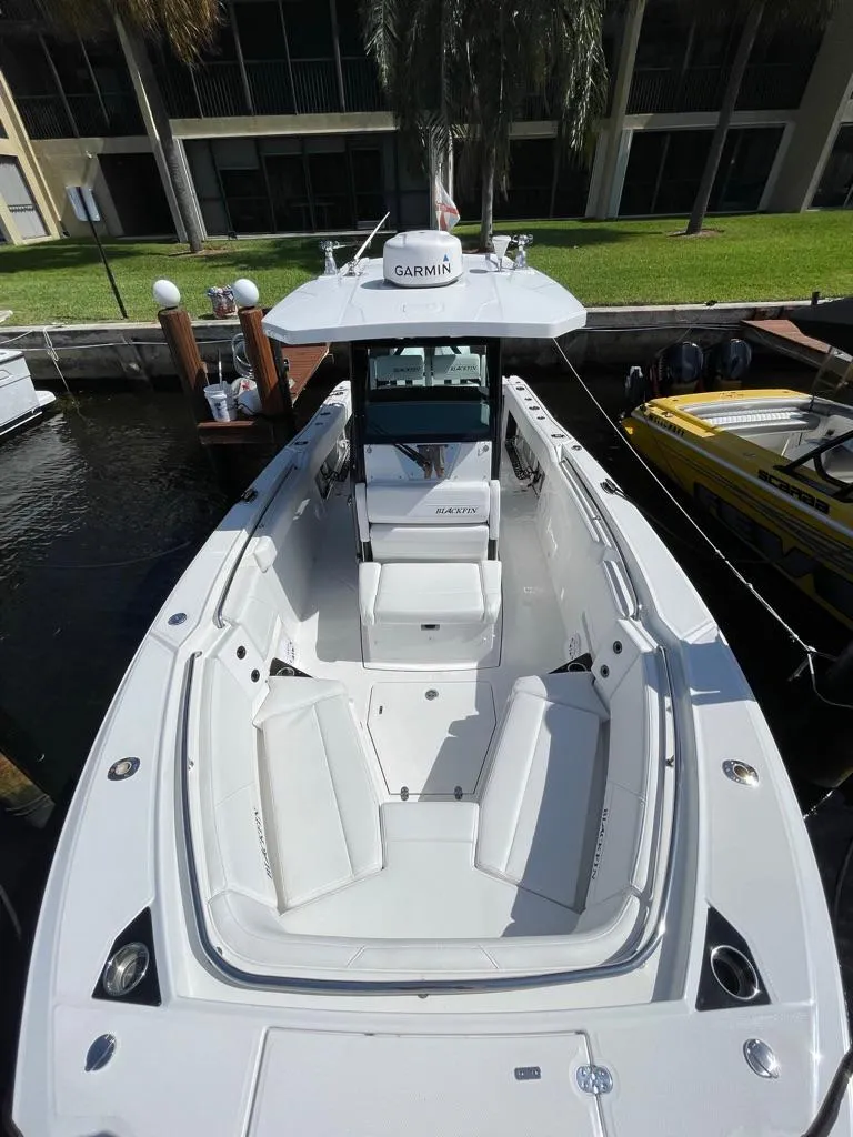 Slide: The Image of 2019 Blackfin 272 CC boat docked, featuring spacious seating and modern design. - 36