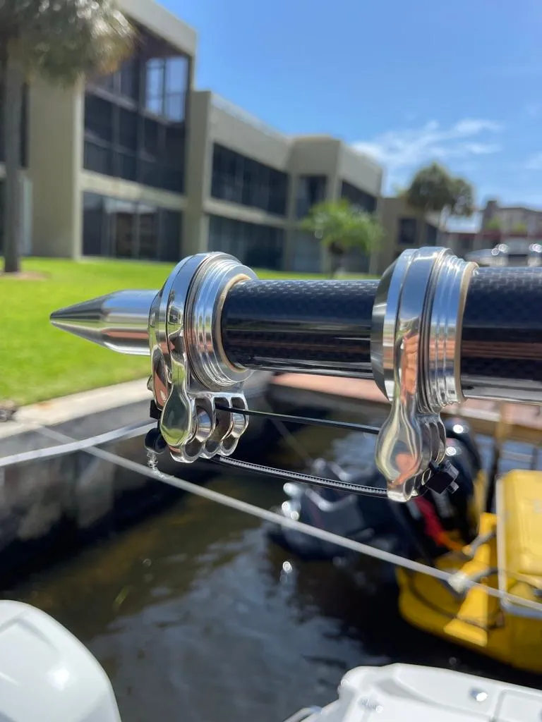 Slide: The Image of Close-up of a 2019 Blackfin 272 CC boat's fishing rod holder, docked near modern buildings. - 42