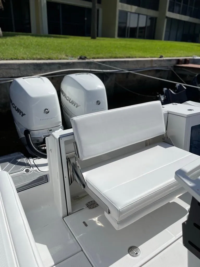 Slide: The Image of 2019 Blackfin 272 CC boat with dual Mercury engines and white seating. - 8