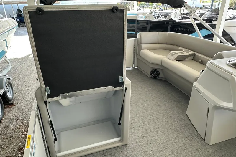 Slide: The Image of 2026 Sweetwater EX2286SBX pontoon boat interior with seating and storage compartment. - 10