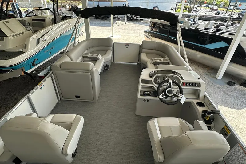 Slide: The Image of 2026 Sweetwater EX2286SBX pontoon boat interior with plush seating and modern helm. - 11