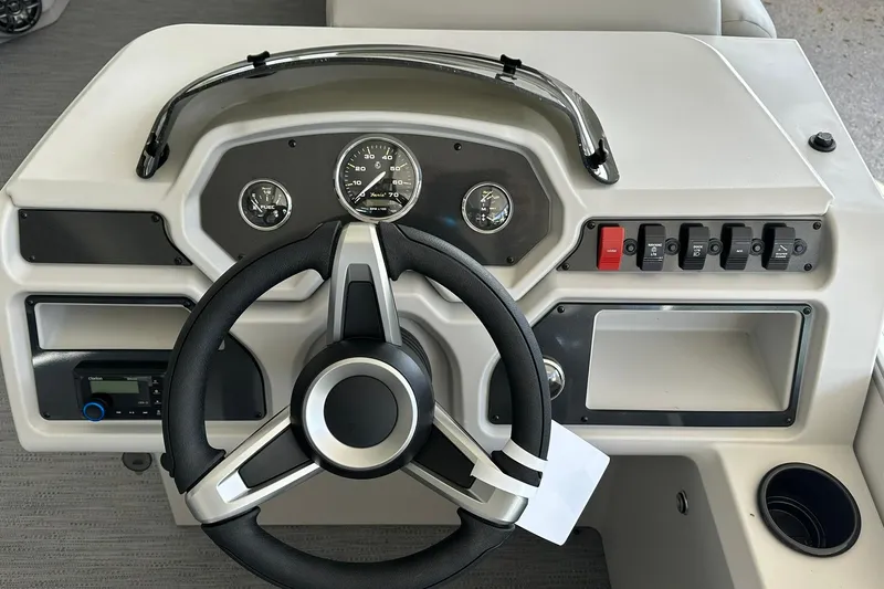 Slide: The Image of Steering console of 2026 Sweetwater EX2286SBX boat with gauges and controls. - 12